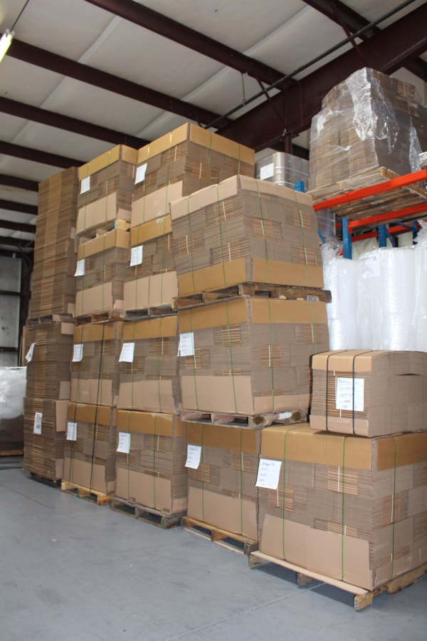 Pallets of corrugated boxes stacked in the Packaging Plus warehouse in Alpharetta, GA